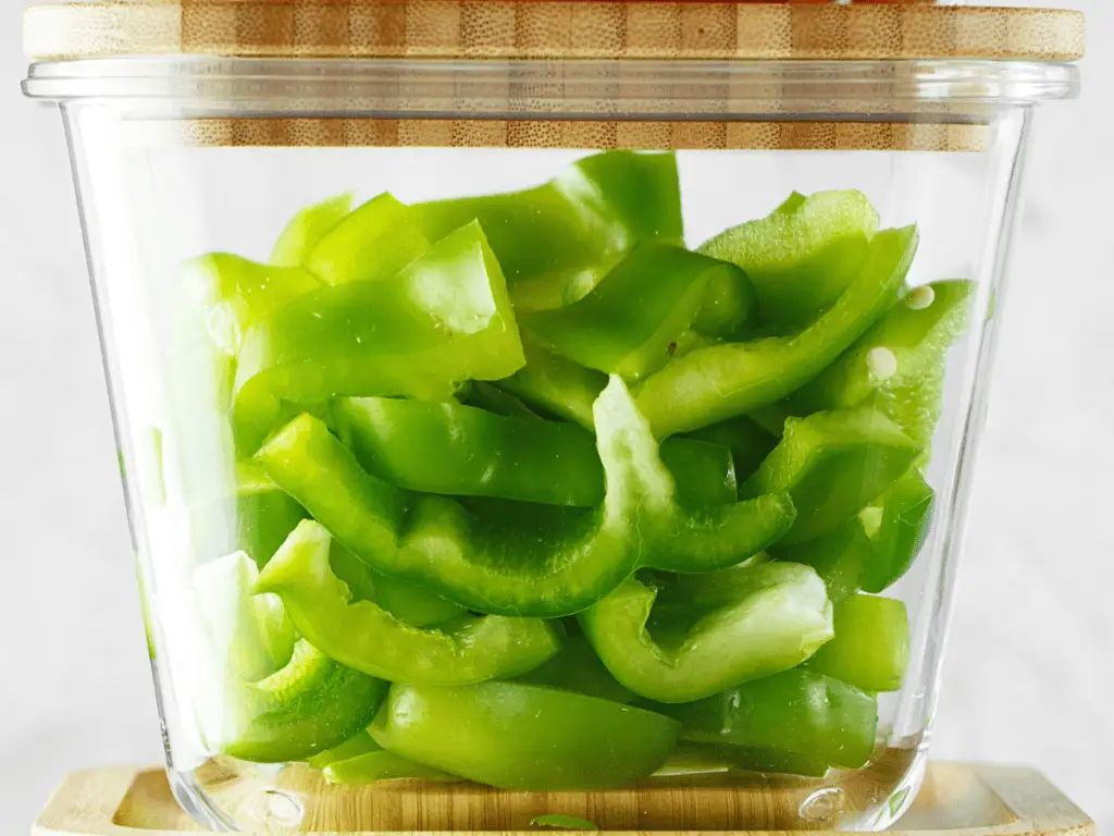 Storing cut peppers in a sealed bag or container will keep them crisp for longer than leaving them exposed to the open air in the refrigerator.